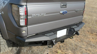 compare product Addictive Desert Designs 10-14 Ford F-150 Raptor HoneyBadger Rear Bumper w/ Tow Hooks