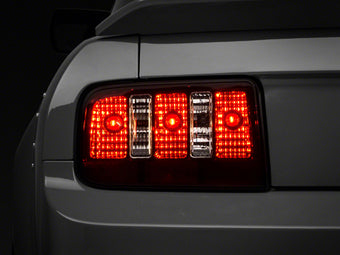 compare product Raxiom 05-09 Ford Mustang Coyote Tail Lights- Black Housing (Smoked Lens)